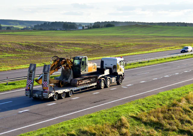 Excavator on flatbed trailer