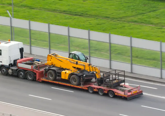 Telehandler on flatbed trailer